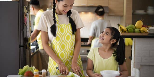 Happy family working and laughing together in kitchen